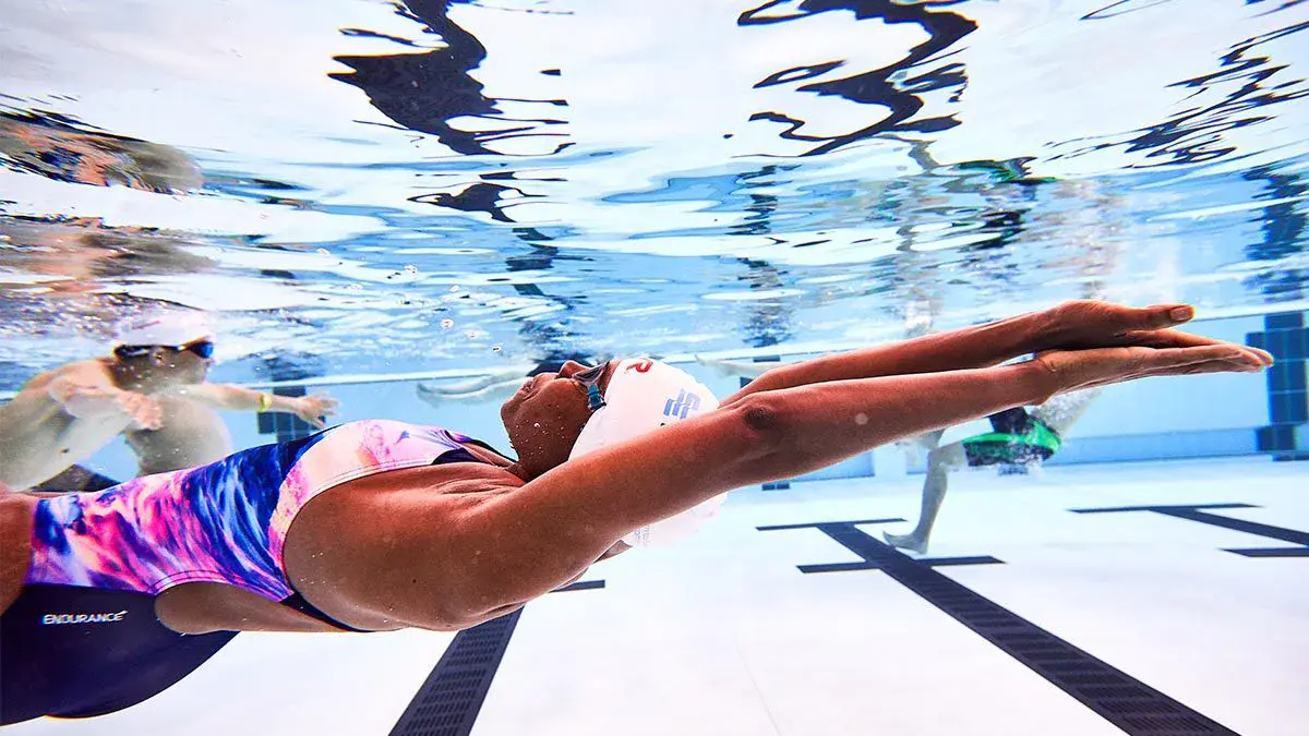 An adult swimming underwater