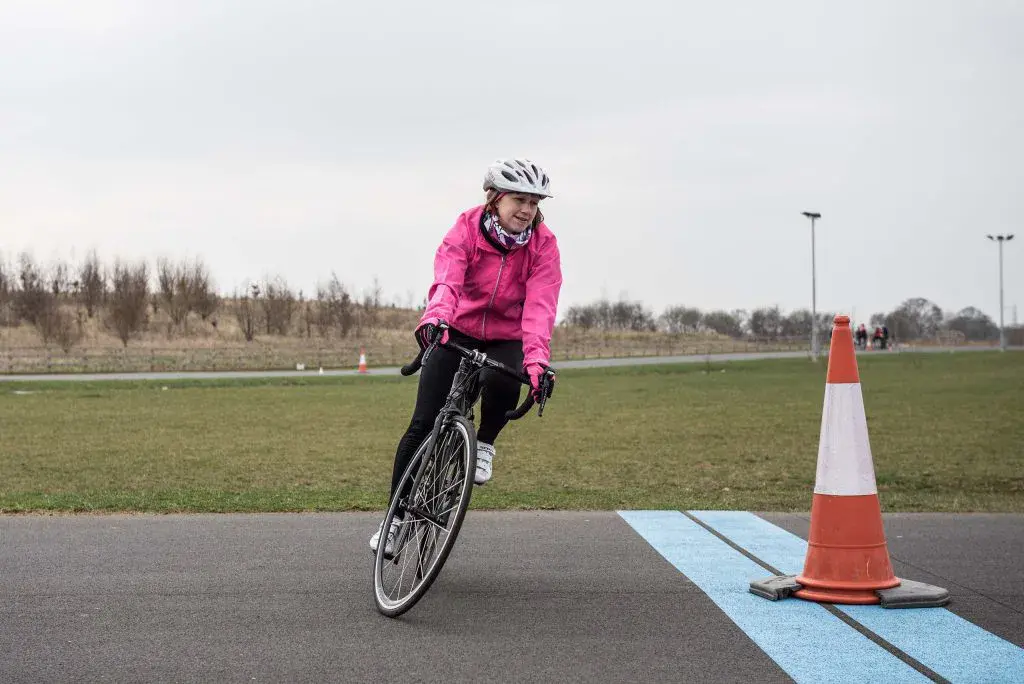 Older lady on bike turning corner